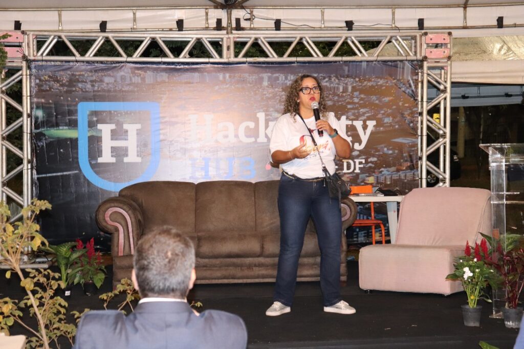 Cristiane Pereira no Palco do Evento Experiência Hackacity realizado em 2023. Promovida pelo Codese, Secretaria de Ciência, Tecnologia e Inovação e administração regional, promove discussão sobre como tornar a cidade mais inteligente.